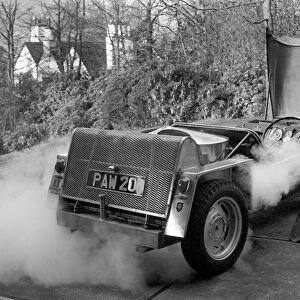 Man driving a steam powered car near his home December 1970 70-11615-002