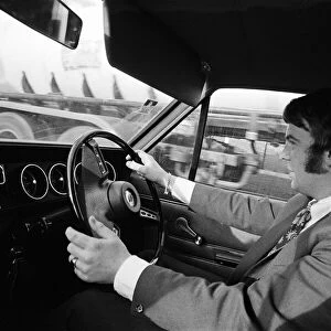 A man driving a Vauxhall car, Albert Park, Middlesbrough, North Yorkshire. 1971