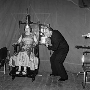 A man electrocuting his wife for a fairground sideshow. Boston, Lincolnshire