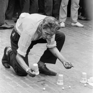 A man entertains crowds on the streets of London with his magic tricks A man entertains crowds on the streets of London with his magic tricks