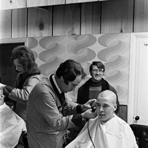 A man getting a "Kojak"hair cut. 1975