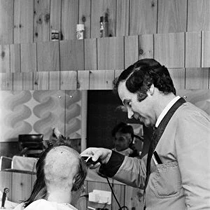 A man getting a "Kojak"hair cut. 1975