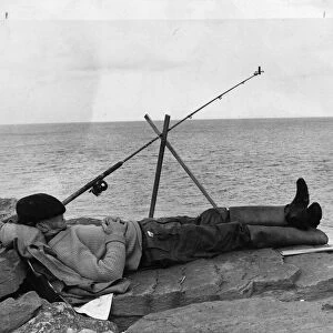 Man having forty winks while fishing. 24th June 1965