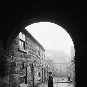 A man inspects a 16th century cottage in Guisborough. Redcar, Cleveland. Circa 1975