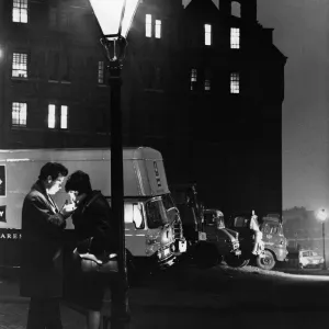 Print of a couple under a street lamp at night, 1965
