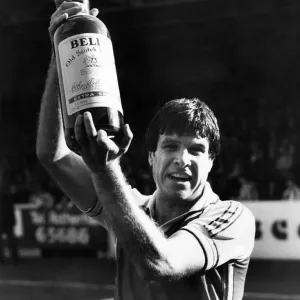 Man of the month - Emlyn Hughes picks up a gallon of scotch while his former mates Man of the month - Emlyn Hughes picks up a gallon of scotch while his former mates