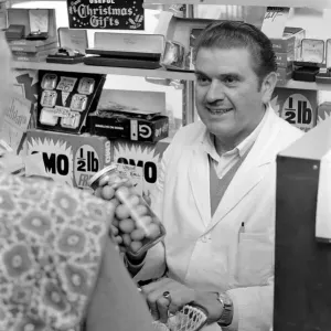 A man serving a customer in his shop at Deptford. November 1969 Z10715-004 A man serving a customer in his shop at Deptford. November 1969 Z10715-004