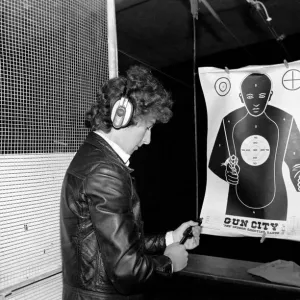 A man shooting at a target during practice at Gun City shooting range in South Africa