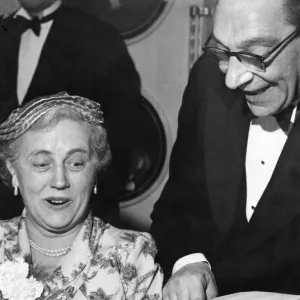 Man showing off a chicken drumstick to a woman at a dinner party Circa 1955 Man showing off a chicken drumstick to a woman at a dinner party Circa 1955