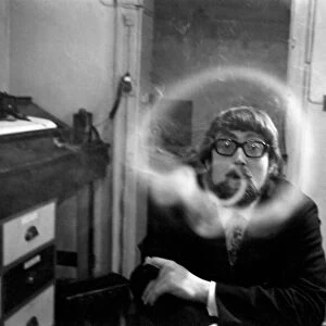 A man smoking a cigarette blowing smoke rings. November 1969 Z12004