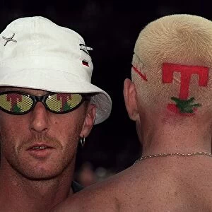 Man with T in the Park logo sunglasses with the back of a mans head with the T in