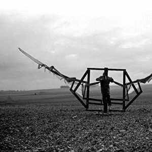 A man trues out his home made flying machine in a field in Wiltshire