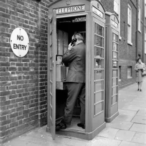 Man in a Red Telephone Box Print Man in a Red Telephone Box Print