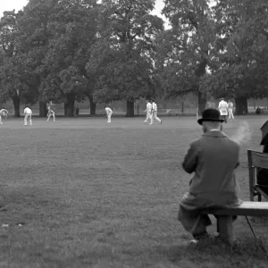 Man watching the cricket and smoking, Ham & Hampton Wick. 2359a Man watching the cricket and smoking, Ham & Hampton Wick. 2359a