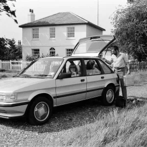 A man, woman and girl with a MG Maestro. 8th June 1983 A man, woman and girl with a MG Maestro. 8th June 1983