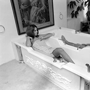Man and woman sharing a bath designed for two. November 1969 Z10586-010