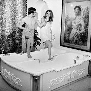 Man and woman sharing a bath designed for two. November 1969 Z10586