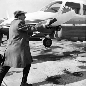 Managing Director Freddie Laker (40) pushes his own aircraft back off the airfield apron