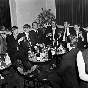 Manchester City players and management staff celebrate with a few drinks