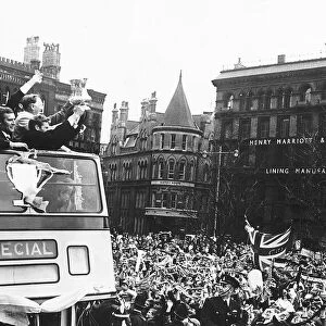 Manchester City team proudly show their supporters the FA Cup as they arrive at the Town