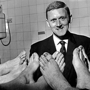 Manchester Citys physiotherapist Peter Blakey inspects the feet of Manchester City