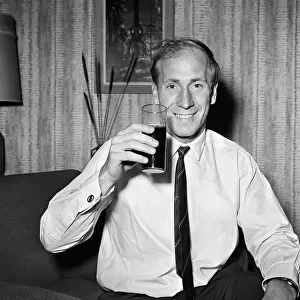 Manchester United and England footballer Bobby Charlton in happy mood at his home in