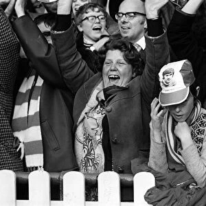 Manchester United Fan wearing George Best hat March 1972 is surrounded by Stoke City fans