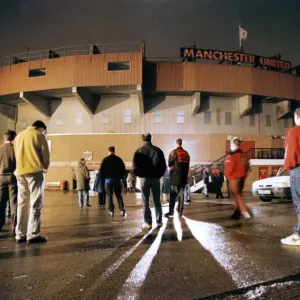 Manchester United fans bow their heads in respect during a slient vigil outside Old Manchester United fans bow their heads in respect during a slient vigil outside Old
