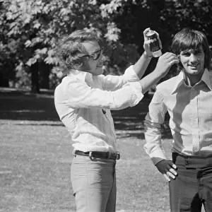 Manchester United footballer George Best has hair spray applied by his personal