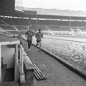Manchester United footballer George Best running around a snow covered pitch at Old Manchester United footballer George Best running around a snow covered pitch at Old
