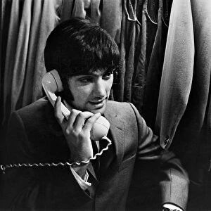 Manchester United footballer George Best at Taylors taking a phone call, circa 1966