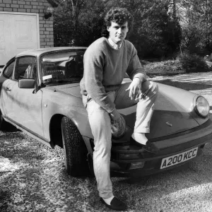 Manchester United footballer Mark Hughes 22, poses with his German built Porsche sports