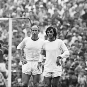 Manchester United footballers Bobby Charlton and George Best await a free kick during Manchester United footballers Bobby Charlton and George Best await a free kick during