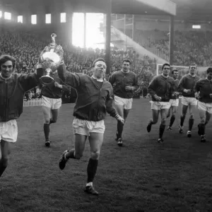 Manchester United footballers George Best and Nobby Stiles hold aloft the League
