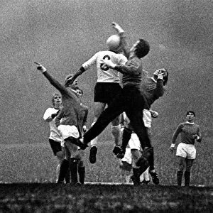 Manchester United goalkeeper Alex Stepney jumps up to punch the ball clear from Liverpool