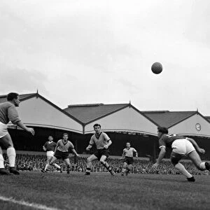 Manchester United goalkeeper Harry Gregg watches closely as th ball comes across his