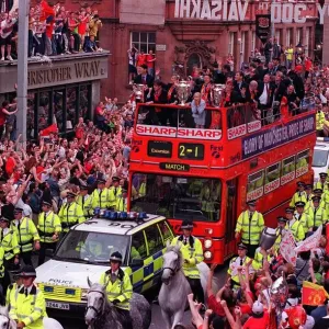 Manchester United Homecoming on an open-top bus May 1999 mobbed by fans at the start of