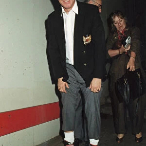 Manchester United manager Alex Ferguson shows off his lucky socks after his teams victory