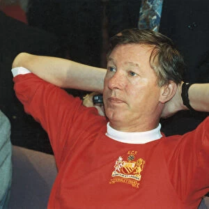 Manchester United manager Alex Ferguson wearing a 1968 European Cup Final shirt for a