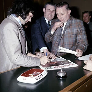 Manchester United and Northern Ireland footballer George Best signs autographs for a fan