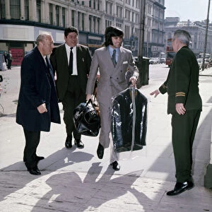 Manchester United and Northern Ireland footballer George Best arrives with a clean suit