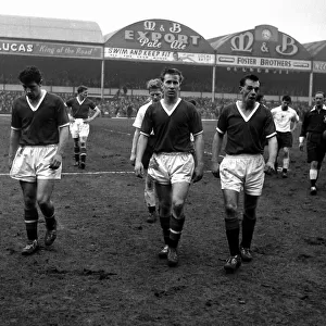 Manchester United players Colin Webster and Bobby Charlton pictured leaving the field