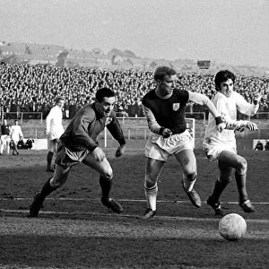 Manchester United star George Best dashes for the ball with Burnley goalkeeper Thomson