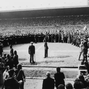 Manchester United supporters crowd onto the pitch at Old Trafford to celebrate their