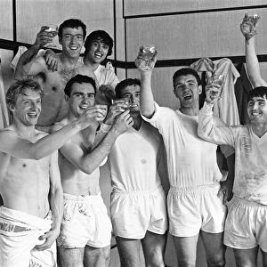Manchester United team celebrate with champagne in the dressing room after winning