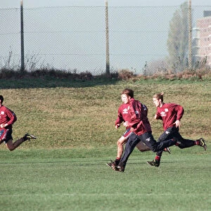 Manchester United in training. David Beckham running with Gary (hidden