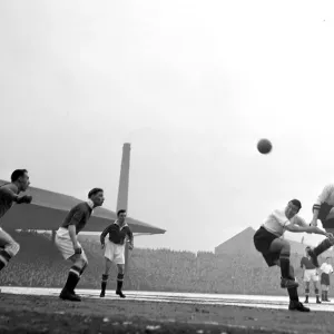 Manchester United versus Aston Villa Pace (left0 leaps higher than colleague Dixon