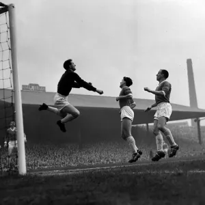 Manchester United versus Manchester City-United goalkeeper Harry Gregg clears