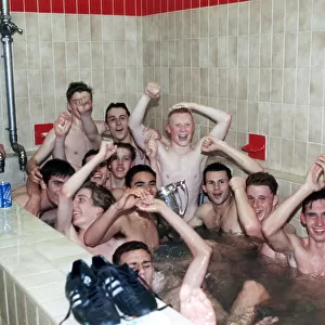 Manchester United youth team celebrate in the bath with the FA Youth Cup trophy after