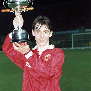 Manchester United youth team player Gary Neville holds up the FA Lancashire Youth Cup